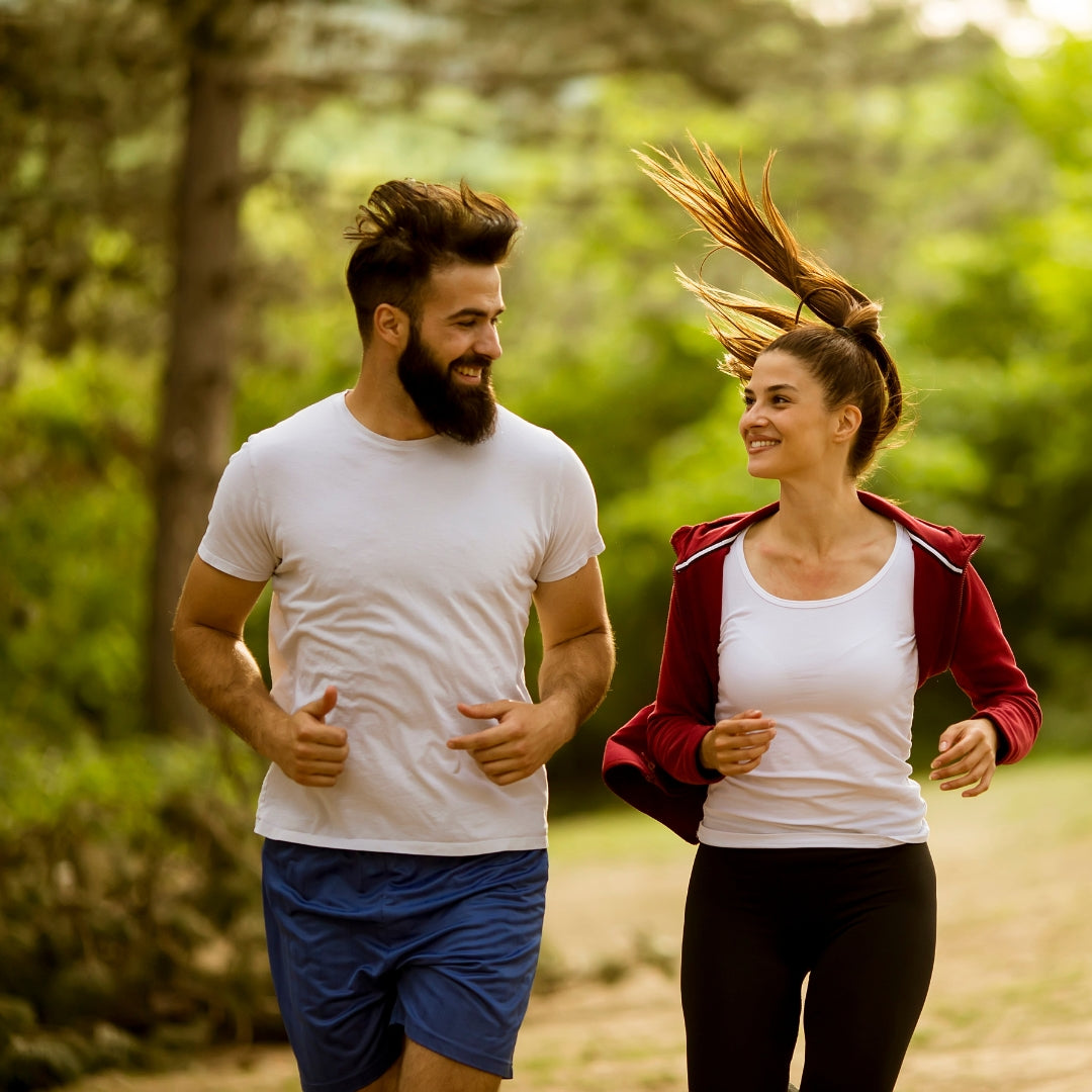 Man and woman jogging together in a park